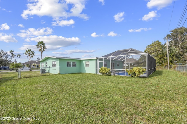 exterior space featuring a lanai and a lawn