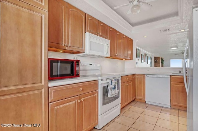 kitchen with white appliances, a textured ceiling, a raised ceiling, ceiling fan, and light tile patterned floors