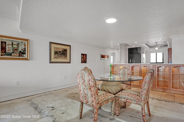 dining room with crown molding and a textured ceiling