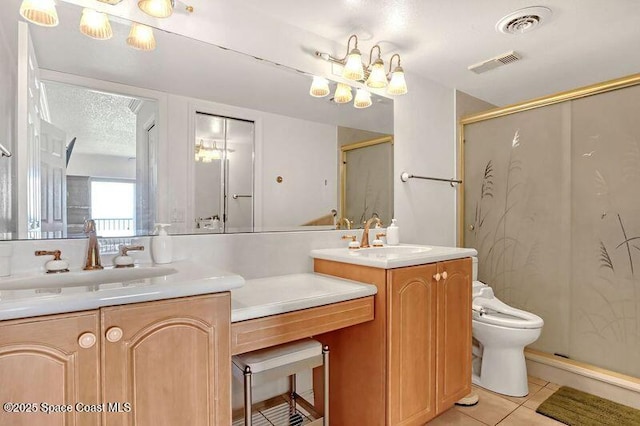 bathroom with vanity, tile patterned flooring, toilet, walk in shower, and a textured ceiling