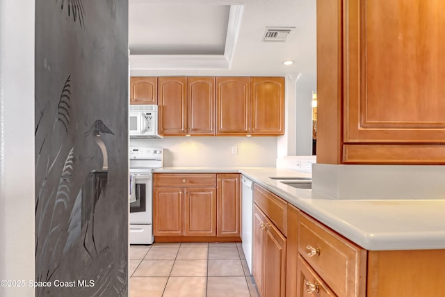 kitchen with white appliances, sink, and light tile patterned floors