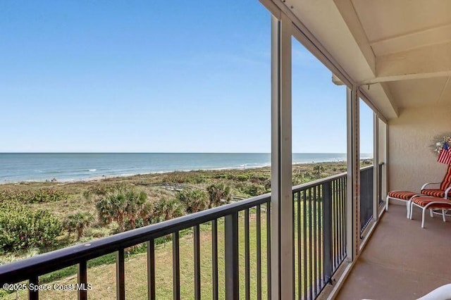 balcony featuring a water view and a view of the beach