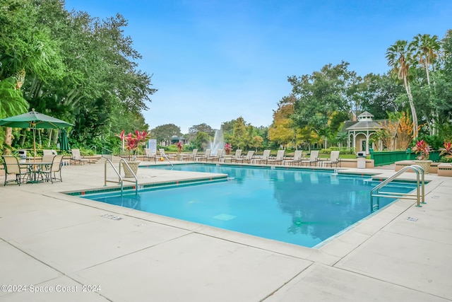 view of swimming pool with a gazebo and a patio area