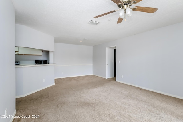 empty room with light colored carpet and ceiling fan