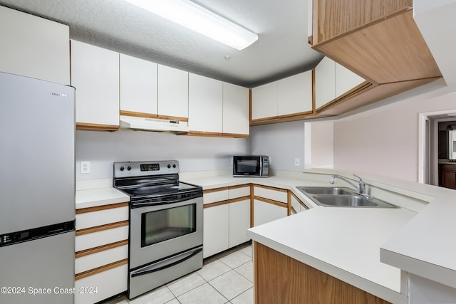 kitchen featuring light tile patterned floors, stainless steel appliances, white cabinetry, and sink