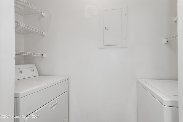 laundry area featuring electric panel and independent washer and dryer