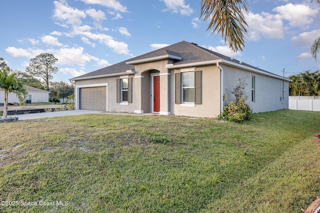 view of front of property with a front lawn and a garage