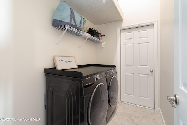 laundry area featuring washing machine and clothes dryer