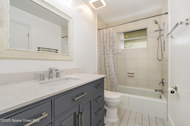 full bathroom featuring vanity, shower / tub combo, and toilet