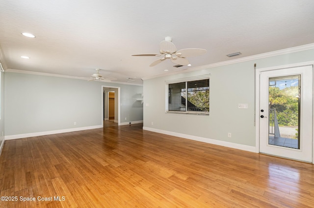 empty room featuring hardwood / wood-style flooring and crown molding