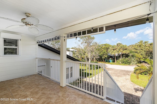 view of patio / terrace with ceiling fan and a balcony