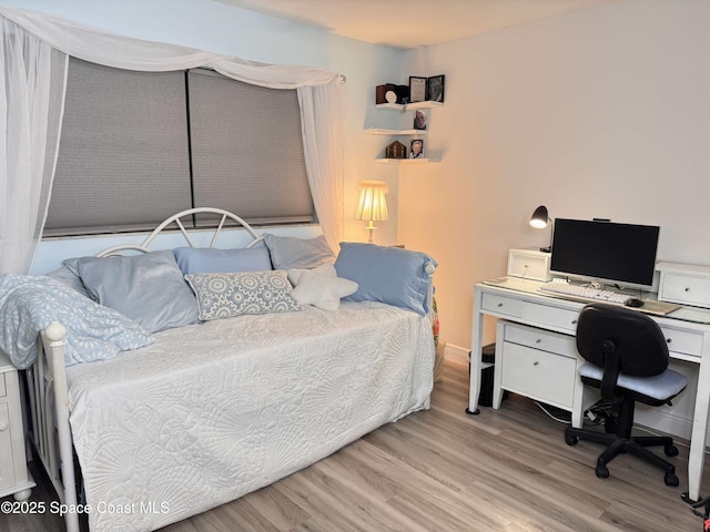 bedroom with light wood-type flooring