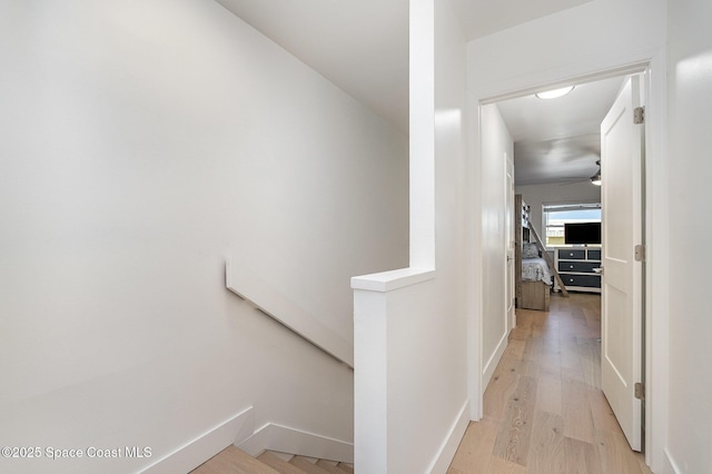 corridor with light hardwood / wood-style flooring