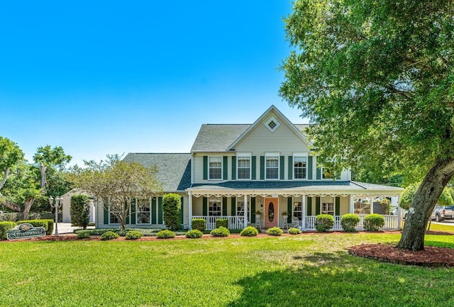 view of front of house with a porch and a front lawn