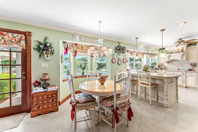 dining space featuring ceiling fan with notable chandelier and ornamental molding