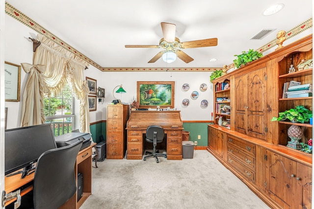 carpeted office space with ceiling fan