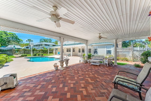 view of patio with ceiling fan and a fenced in pool