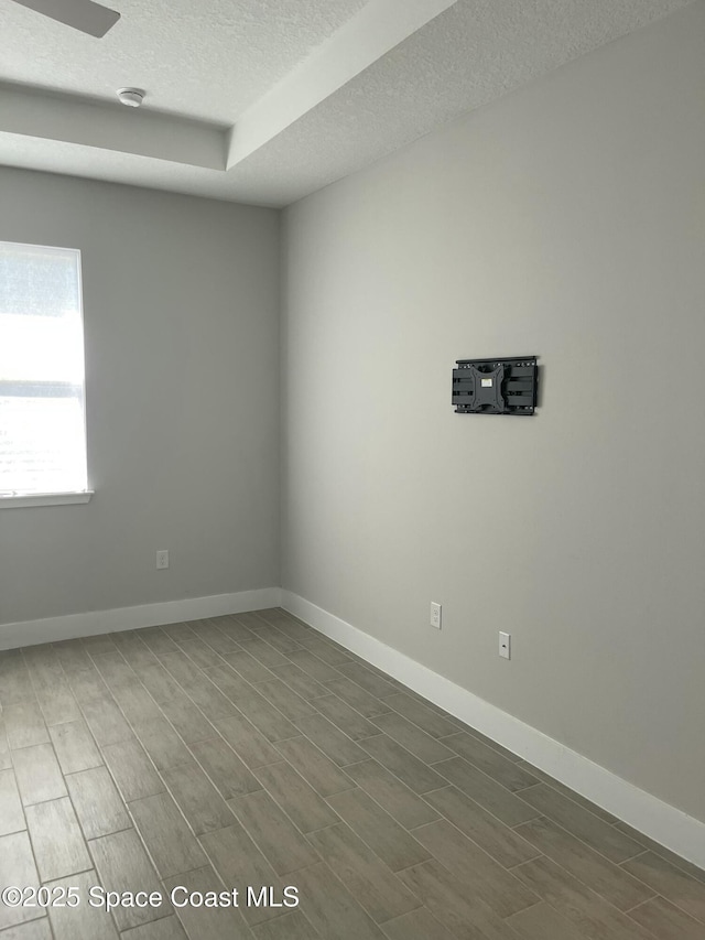 unfurnished room with a textured ceiling