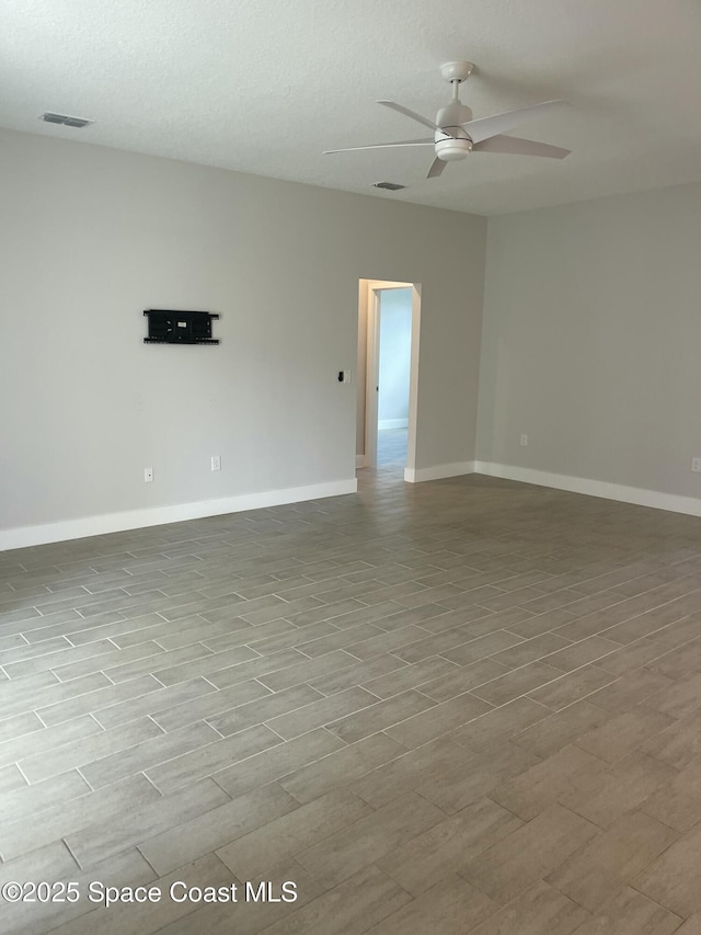 unfurnished room with a textured ceiling and ceiling fan