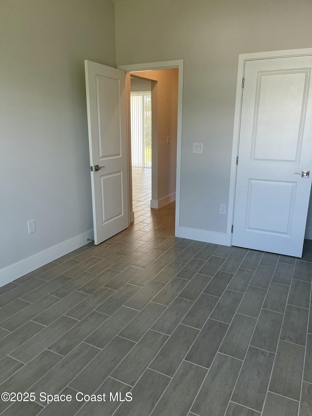 unfurnished room with dark wood-type flooring