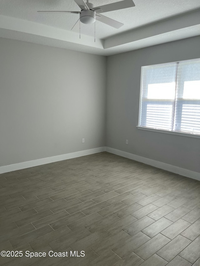 spare room featuring a textured ceiling, dark hardwood / wood-style floors, and ceiling fan