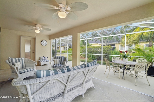 sunroom / solarium featuring ceiling fan