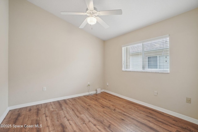 empty room with hardwood / wood-style floors, vaulted ceiling, and ceiling fan