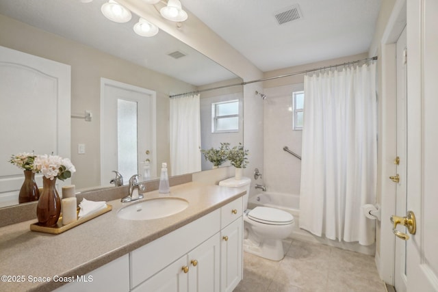 full bathroom featuring shower / bath combo, vanity, and toilet