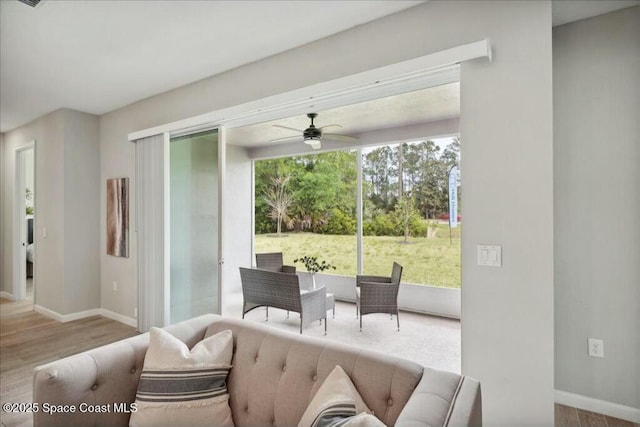 living room with ceiling fan and light hardwood / wood-style floors