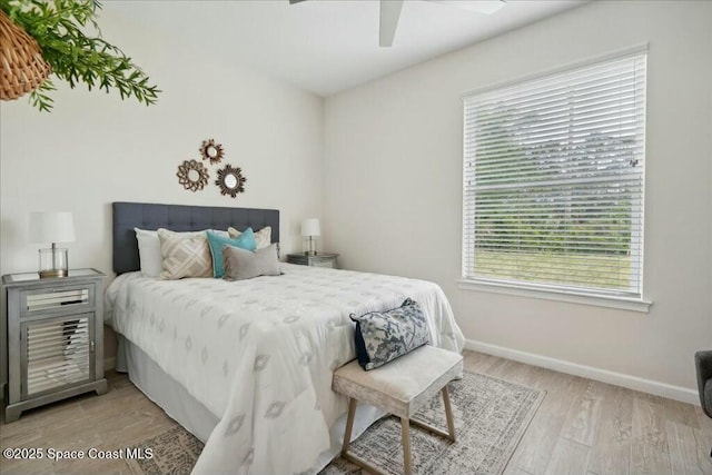 bedroom with ceiling fan and light hardwood / wood-style flooring