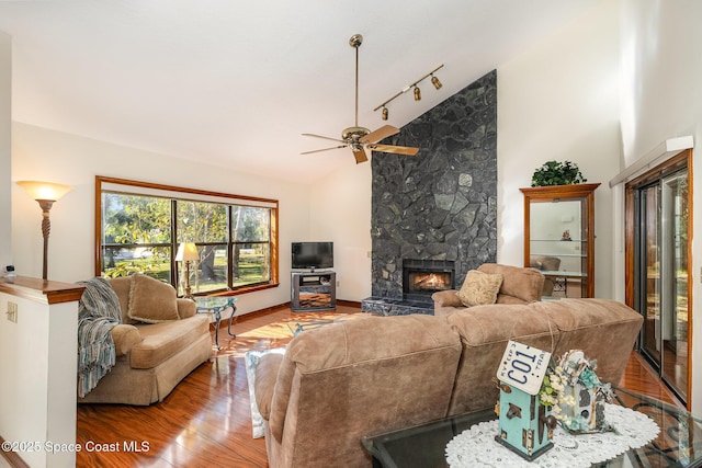 living room featuring hardwood / wood-style floors, ceiling fan, a fireplace, and high vaulted ceiling