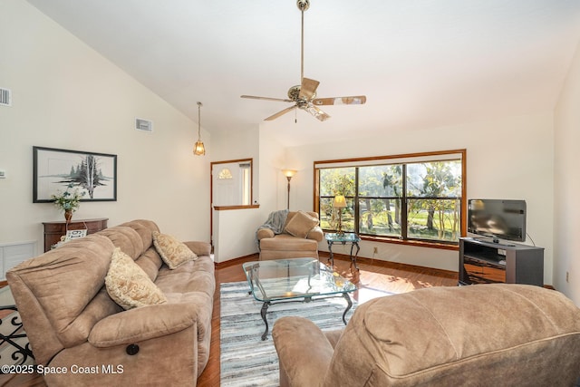 living room with hardwood / wood-style flooring, ceiling fan, and high vaulted ceiling