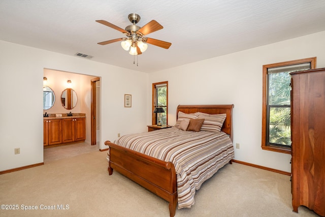 carpeted bedroom featuring ceiling fan and connected bathroom