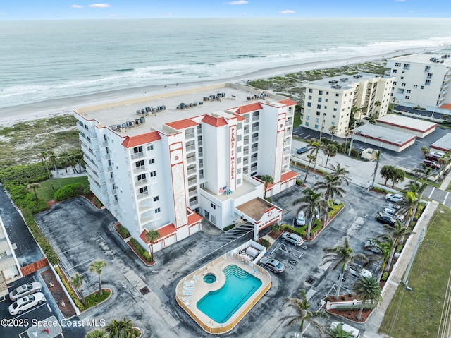 aerial view with a water view and a beach view