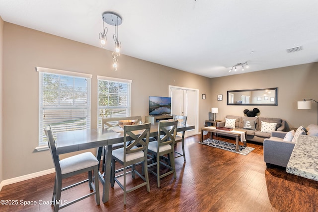 dining room with dark hardwood / wood-style flooring