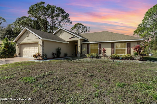 ranch-style home with a lawn and a garage