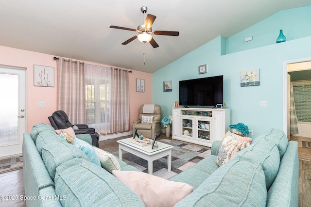 living room featuring wood-type flooring, ceiling fan, and lofted ceiling