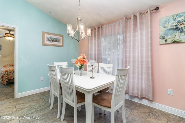 dining space featuring ceiling fan with notable chandelier