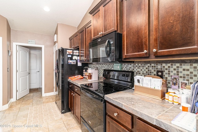 kitchen with tasteful backsplash, light tile patterned flooring, and black appliances