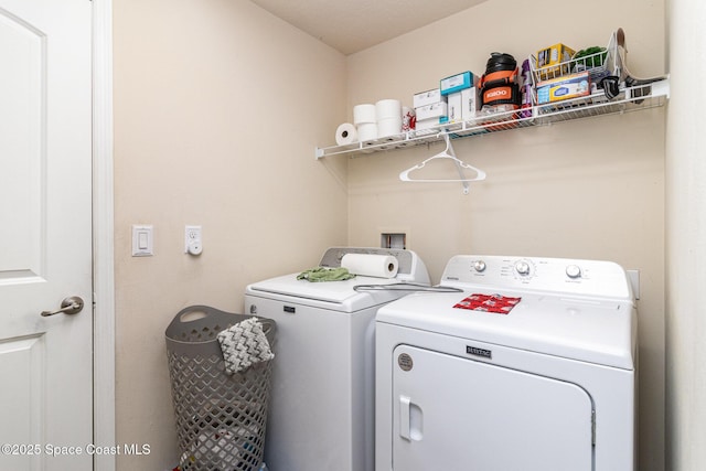 clothes washing area featuring washing machine and clothes dryer