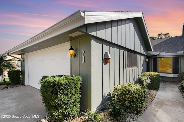 property exterior at dusk with a garage