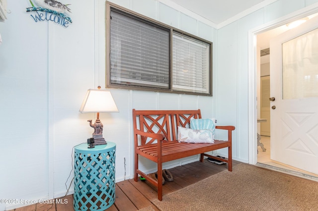 sitting room with hardwood / wood-style flooring and ornamental molding