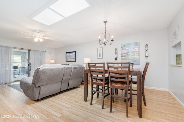 dining area featuring ceiling fan with notable chandelier and light wood-type flooring