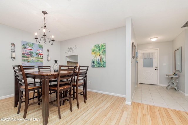 dining space featuring a chandelier and light hardwood / wood-style flooring