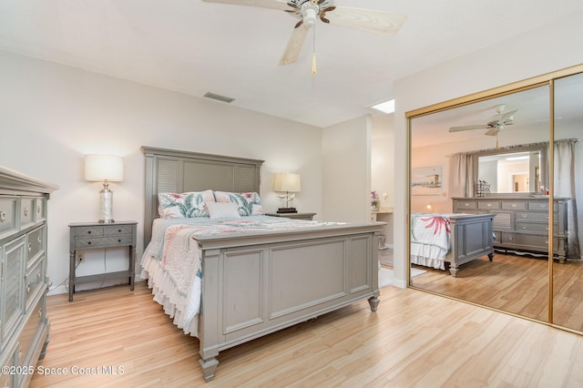 bedroom featuring light hardwood / wood-style flooring, a closet, and ceiling fan