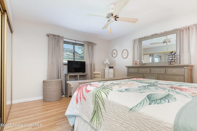 bedroom with a closet, ceiling fan, and light hardwood / wood-style flooring