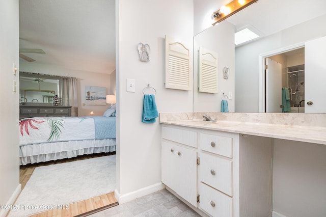 bathroom with a shower, ceiling fan, and vanity