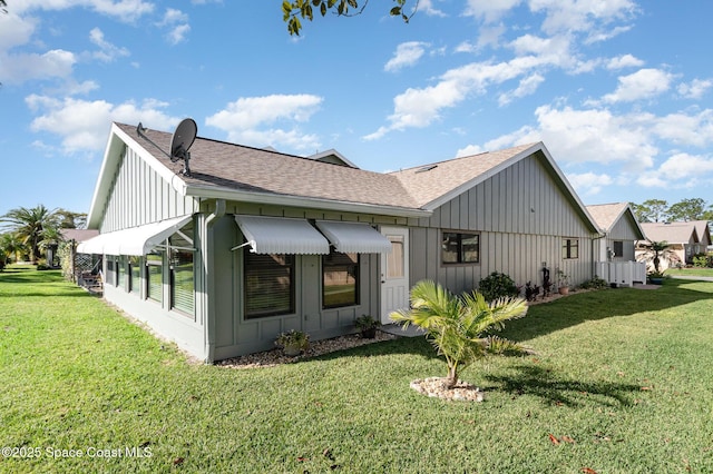 back of property with a lawn