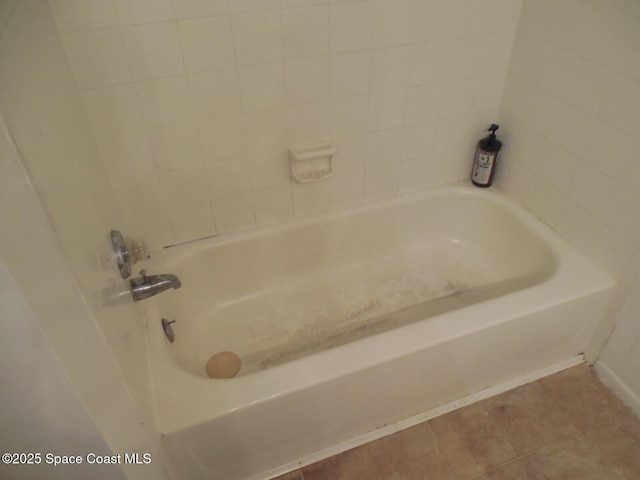 bathroom featuring tile patterned flooring and a bathtub