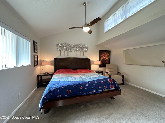 carpeted bedroom with ceiling fan and lofted ceiling